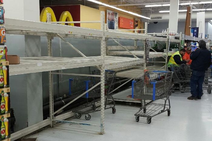 This image of nearly empty shelves of bottled water indicates